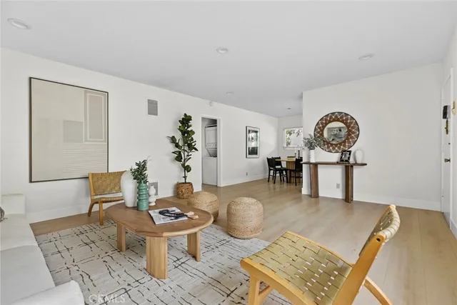 a living room with furniture a rug and a table