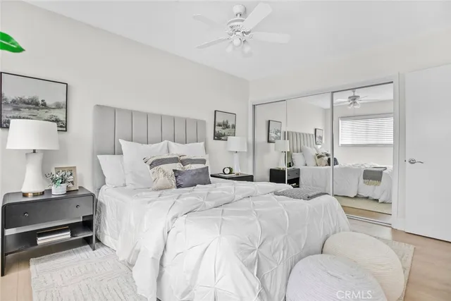 a bedroom with a bed and ceiling fan