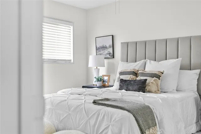 a bedroom with bed and window