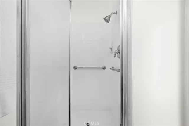 a bathroom with a glass shower door