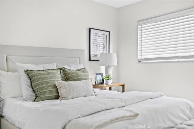 a bedroom with a large bed and a couch