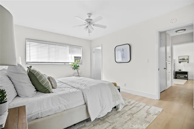 a bedroom with a bed and ceiling fan