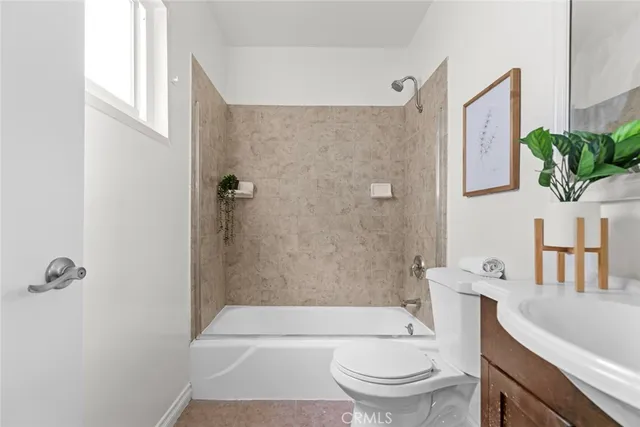 a bathroom with a toilet a sink and bathtub