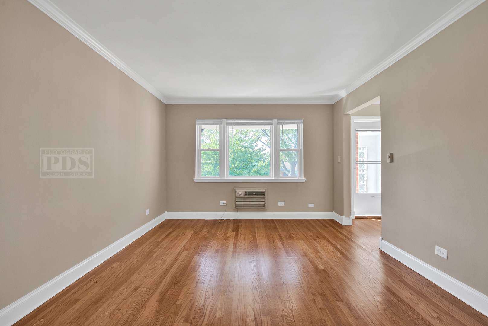 1427 Homestead Road, Unit G La Grange Park, IL 60526 - Photo 3 of 15 an empty room with wooden floor and windows