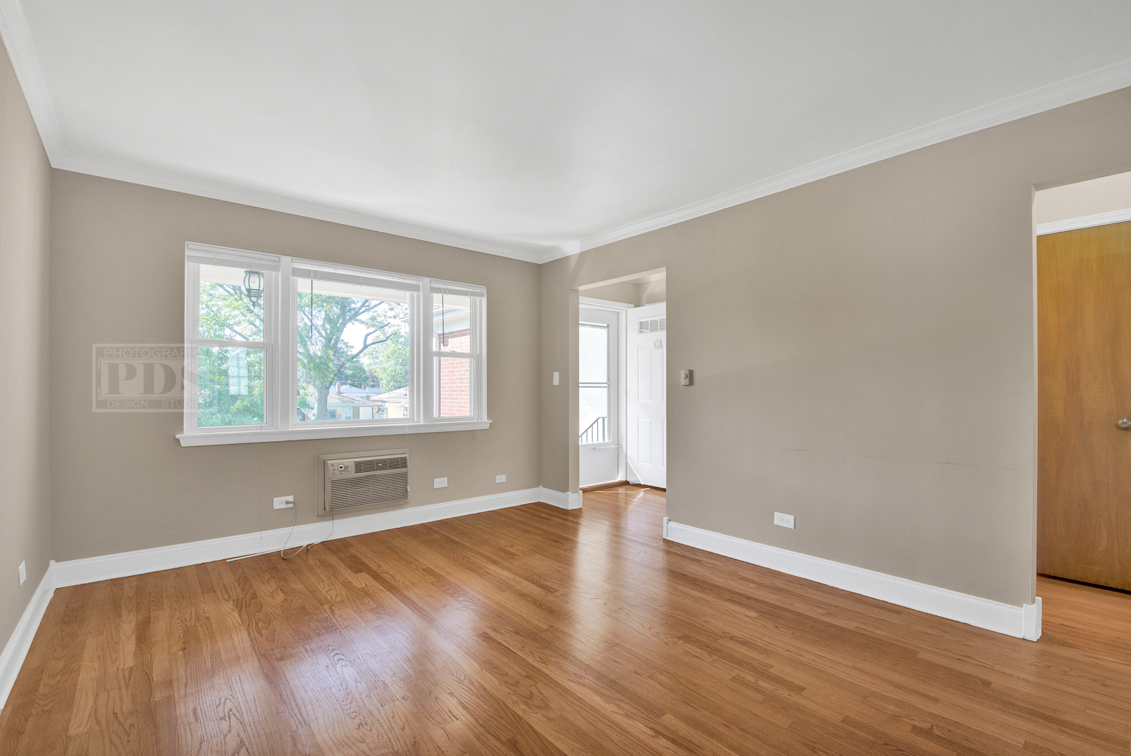 1427 Homestead Road, Unit G La Grange Park, IL 60526 - Photo 4 of 15 an empty room with wooden floor and windows
