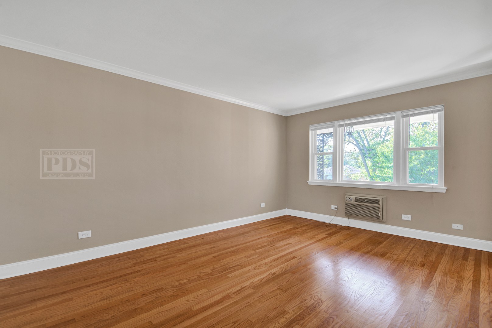 1427 Homestead Road, Unit G La Grange Park, IL 60526 - Photo 5 of 15 an empty room with wooden floor and windows