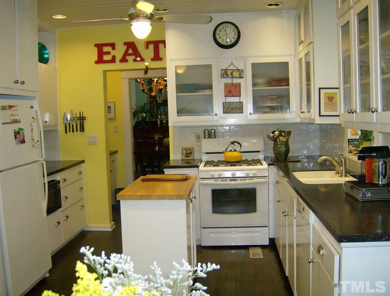 221 Forest Road Raleigh, NC 27605 - Photo 12 of 25 a kitchen with a sink stove and cabinets
