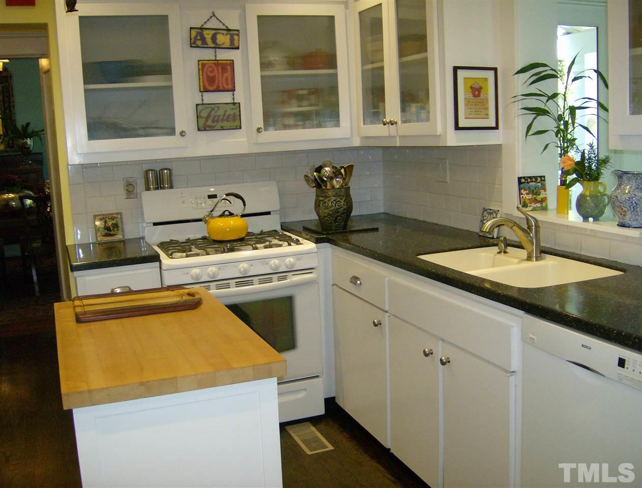 221 Forest Road Raleigh, NC 27605 - Photo 13 of 25 a kitchen with stainless steel appliances granite countertop a sink stove and cabinets