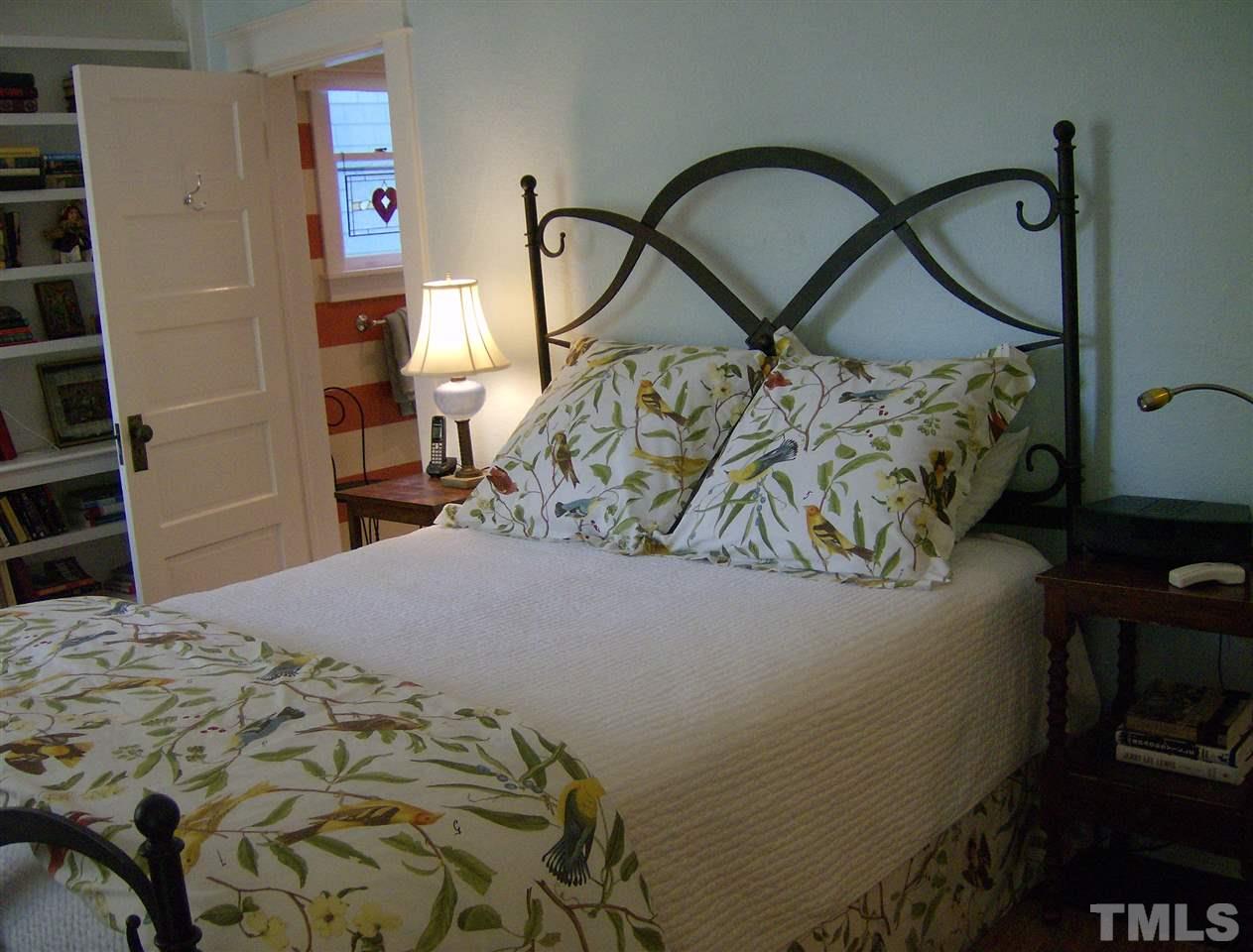 221 Forest Road Raleigh, NC 27605 - Photo 17 of 25 a bed sitting in a bedroom next to a window and closet