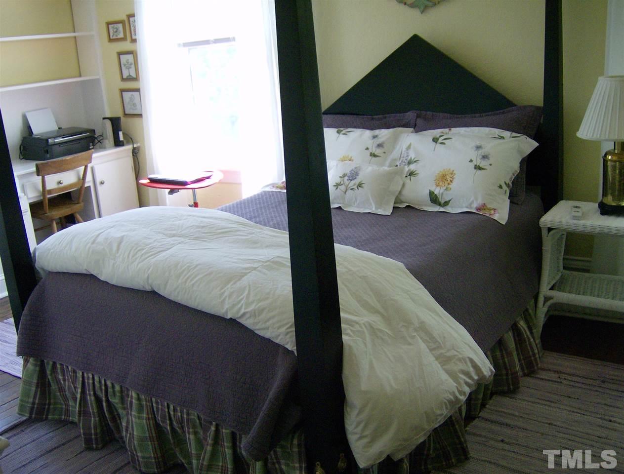 221 Forest Road Raleigh, NC 27605 - Photo 18 of 25 a bed sitting in a bedroom next to a small yard