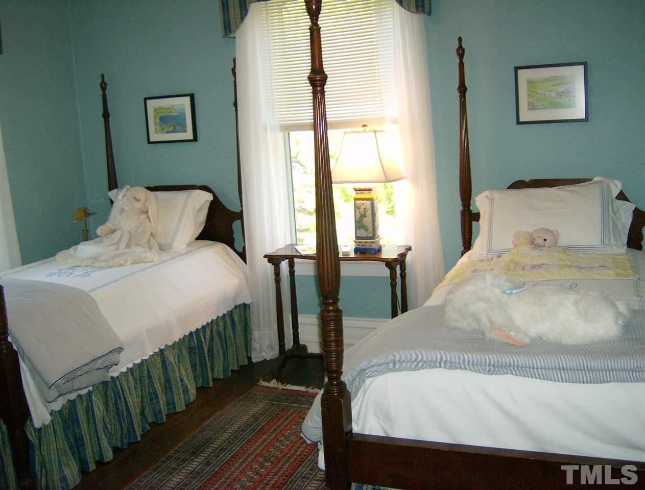 221 Forest Road Raleigh, NC 27605 - Photo 19 of 25 a bedroom with a bed and a large window