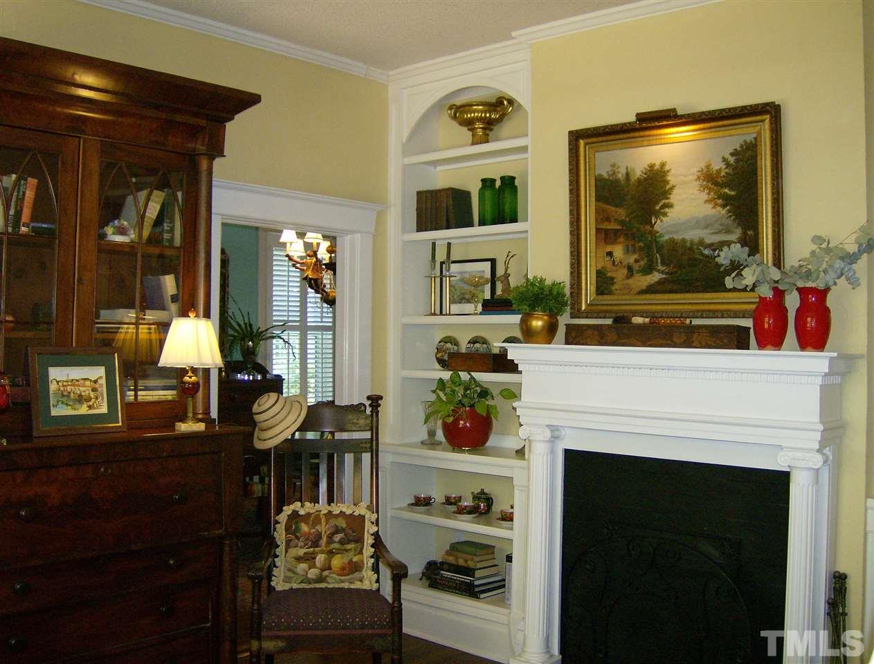 221 Forest Road Raleigh, NC 27605 - Photo 3 of 25 a living room with furniture a flat screen tv and a fireplace