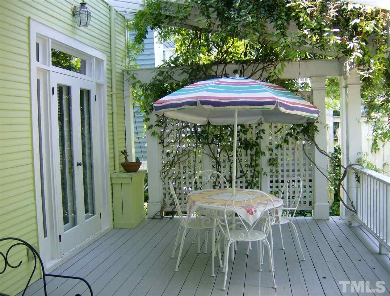 221 Forest Road Raleigh, NC 27605 - Photo 22 of 25 a patio with wooden floor table and chairs