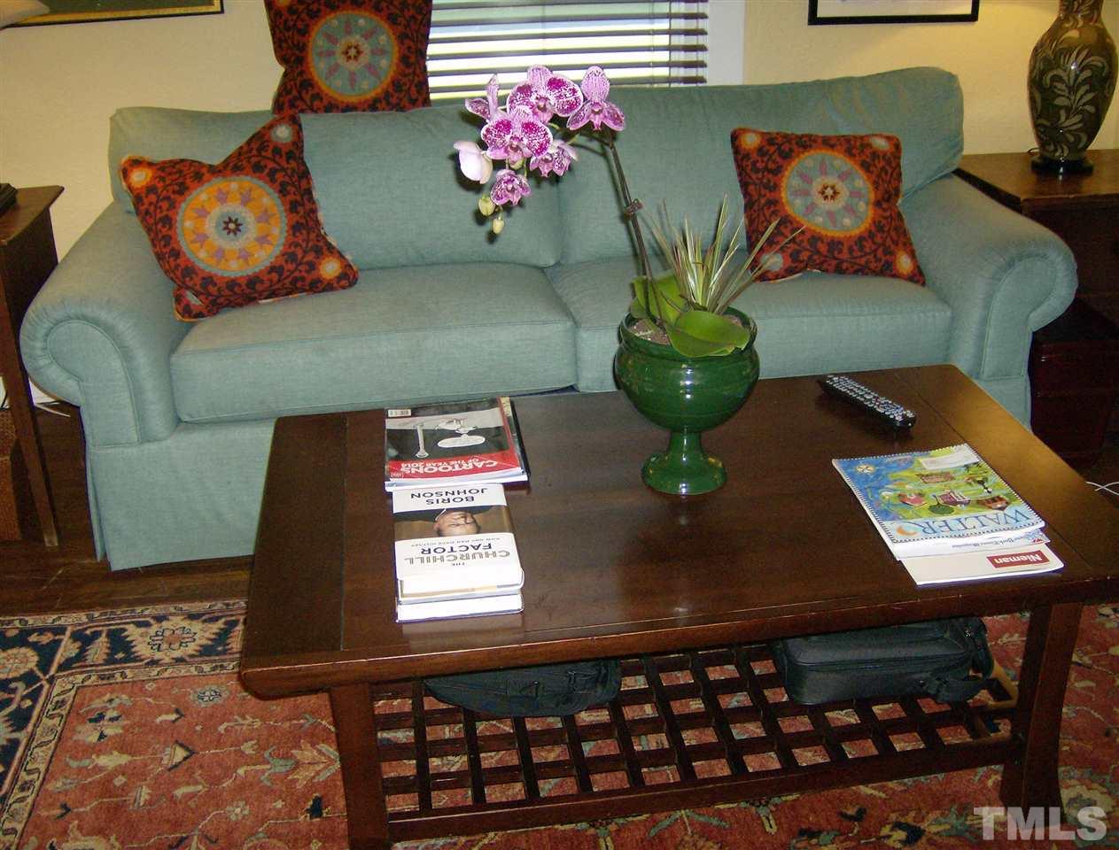 221 Forest Road Raleigh, NC 27605 - Photo 10 of 25 a view of a dining table with paintings on the wall