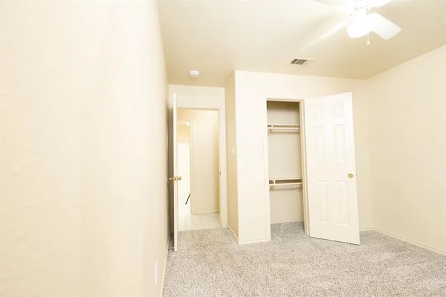 a view of a room with a walk in closet with wooden floor