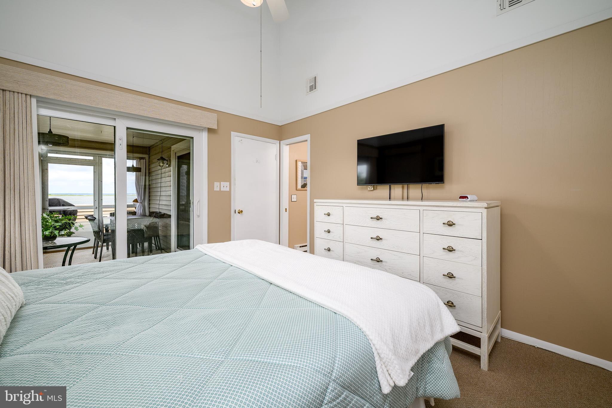 24 Joan Road Long Beach Township, NJ 08008 - Photo 23 of 66 a bedroom with a bed and a flat screen tv