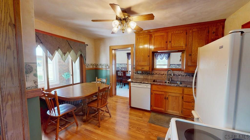 915 Miller Picking Road Davidsville, PA 15928 - Photo 3 of 30 a kitchen with granite countertop cabinets a dining table and chairs