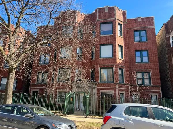 a view of a brick building next to a road