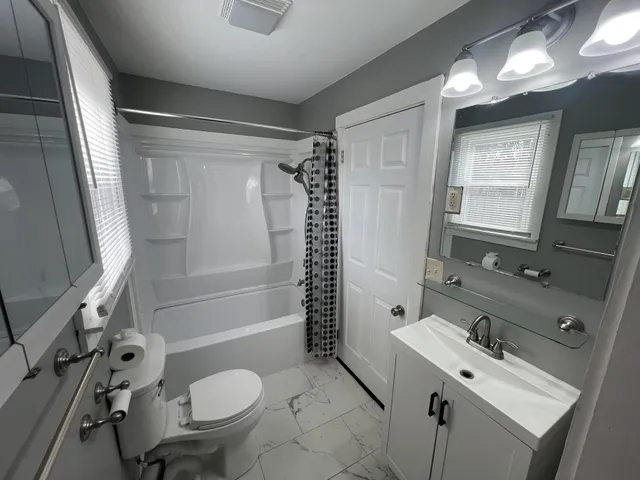 a bathroom with a sink toilet and shower