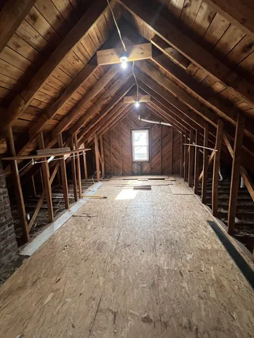 a front view of a house with a yard covered with snow in front of house