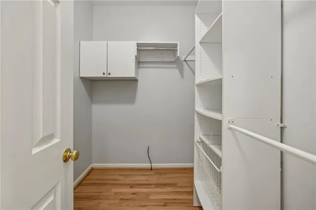 a view of walk in closet with empty racks