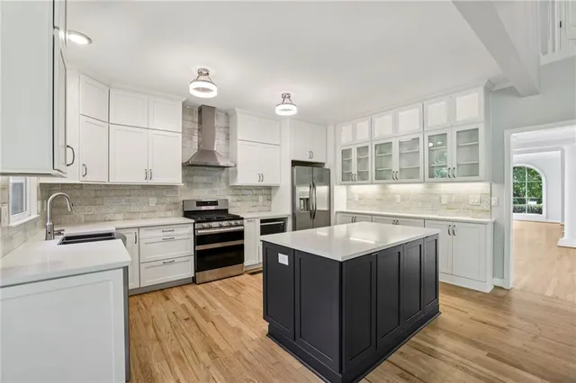 a kitchen with stainless steel appliances granite countertop a stove oven and a refrigerator
