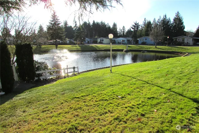 a view of a lake with houses in the back