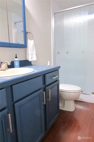 a bathroom with a sink a toilet and mirror