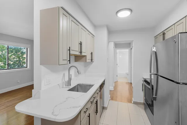 a kitchen with stainless steel appliances a sink a refrigerator and a stove