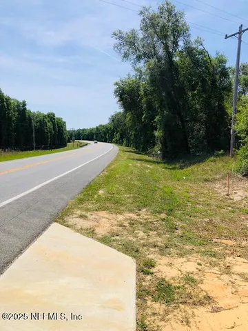 a view of a swimming pool with an outdoor seating and a garden
