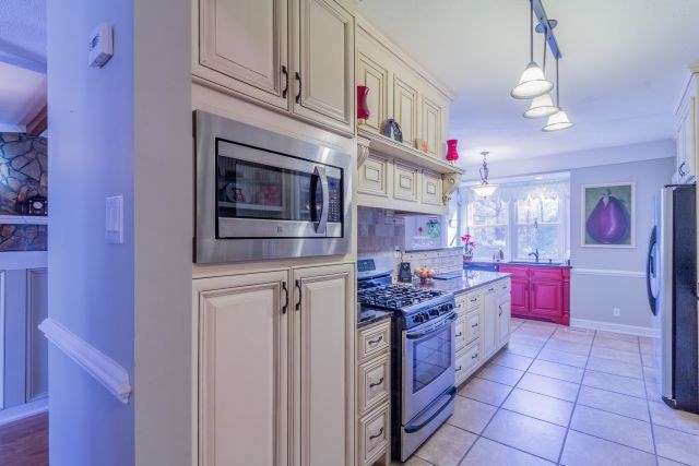 1630 Johnson Road Musella, GA 31066 - Photo 11 of 28 a kitchen with stainless steel appliances granite countertop a stove and cabinets