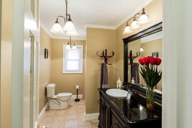 1630 Johnson Road Musella, GA 31066 - Photo 12 of 28 a bathroom with a toilet sink and mirror