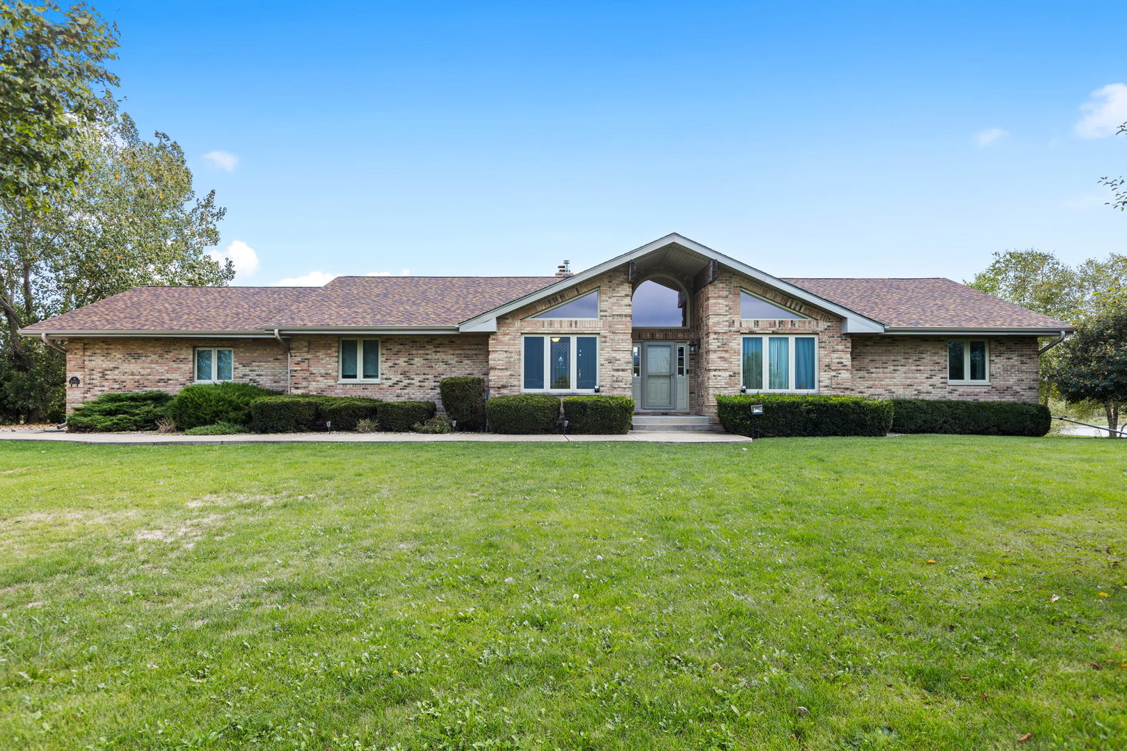 2050 South Spencer Road New Lenox, IL 60451 - Photo 1 of 33 a front view of a house with a garden