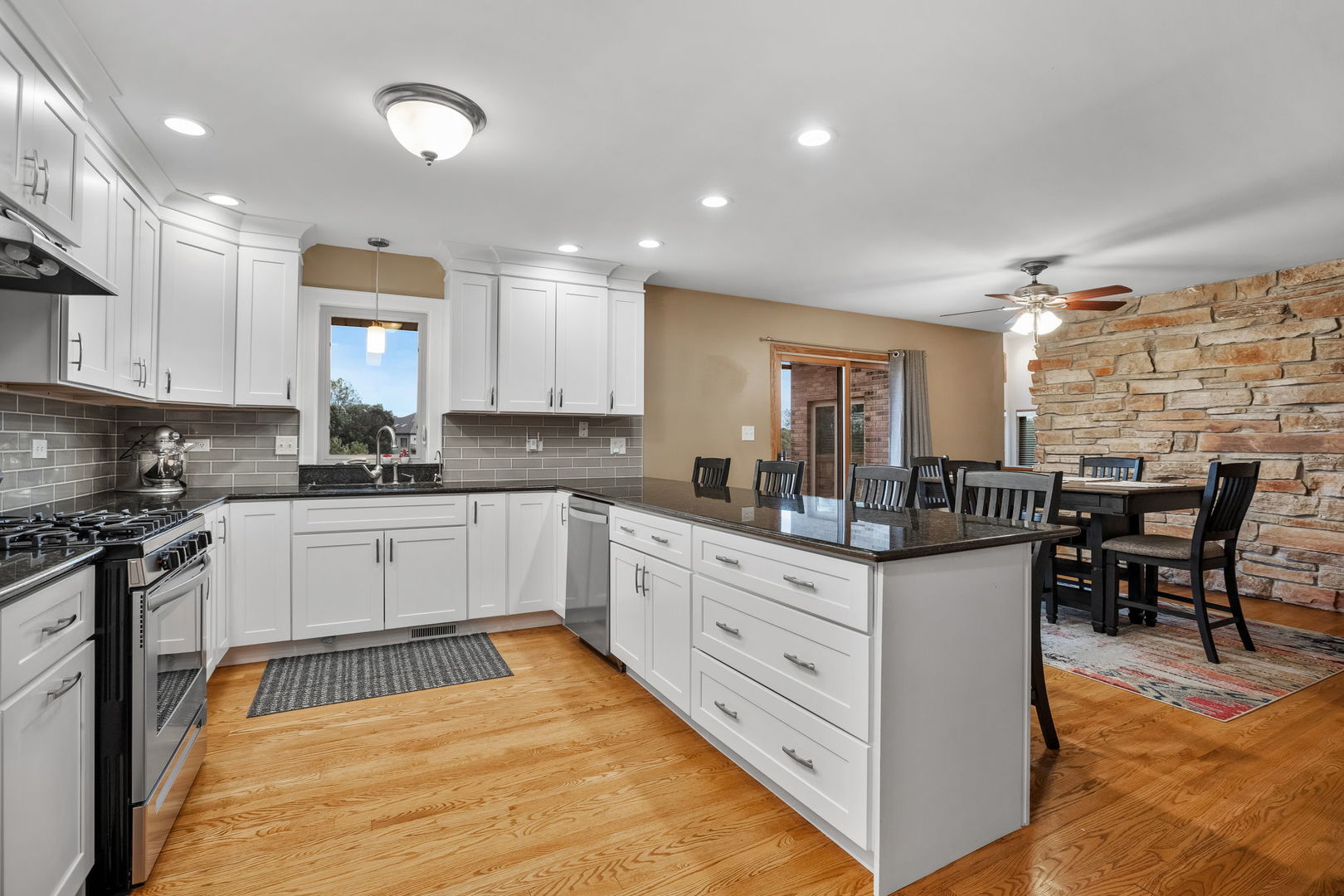 2050 South Spencer Road New Lenox, IL 60451 - Photo 20 of 33 a kitchen with granite countertop white cabinets and white appliances