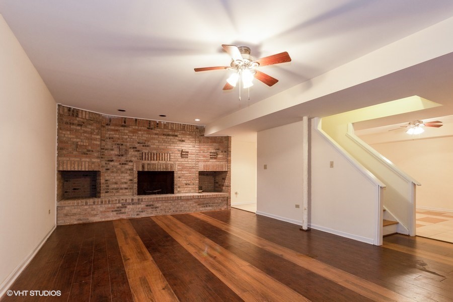 2050 South Spencer Road New Lenox, IL 60451 - Photo 30 of 33 a view of a livingroom with a fireplace and wooden floor