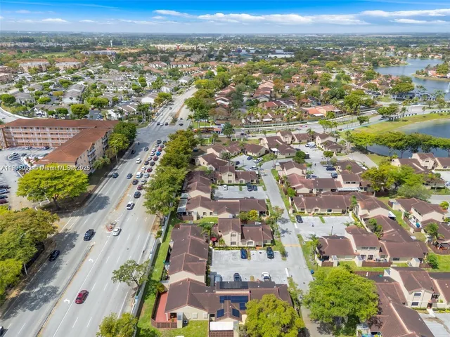 an aerial view of residential building with green space