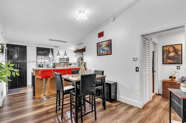 a dining room with furniture and wooden floor