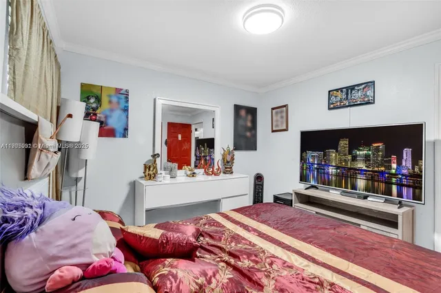 a bedroom with furniture and a flat screen tv