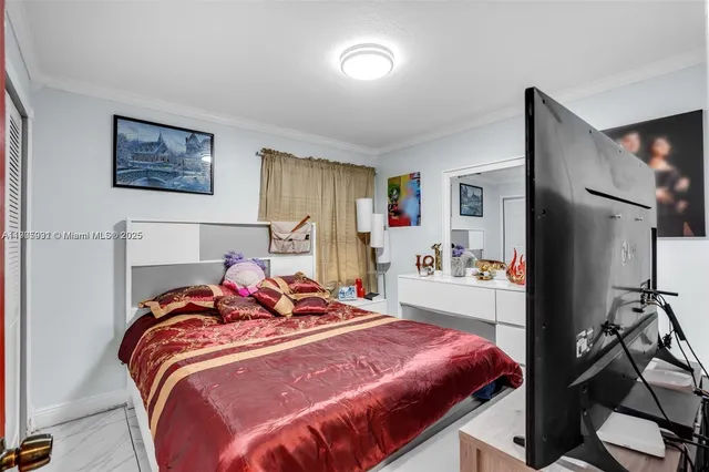 a bedroom with bed and a window