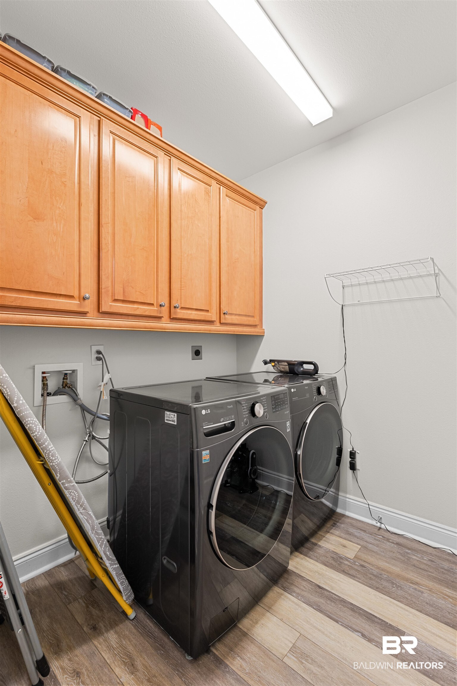 141 Mark Twain Loop Foley, AL 36535 - Photo 30 of 55 Laundry area with cabinet space, light wood finished floors, and washer and dryer