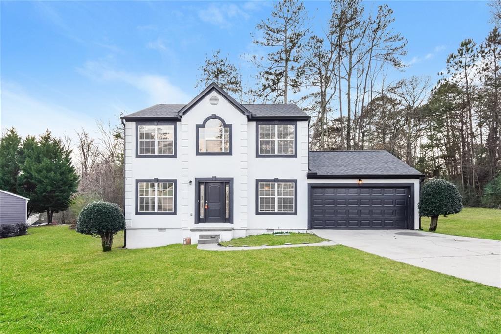 971 Shadow Ridge Trail Lithonia, GA 30058 - Photo 1 of 1 a front view of a house with a yard