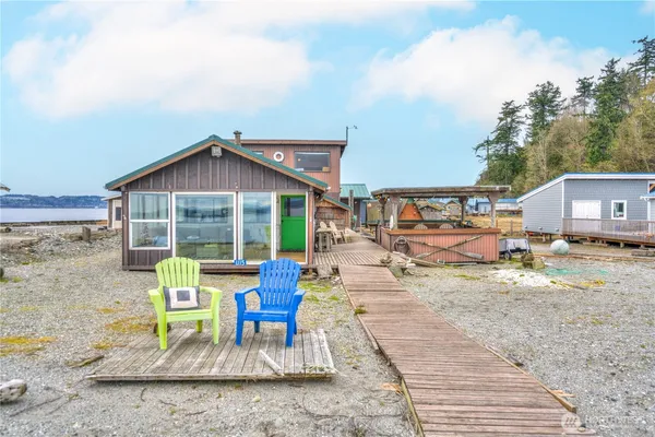 a view of a house with backyard porch and sitting area