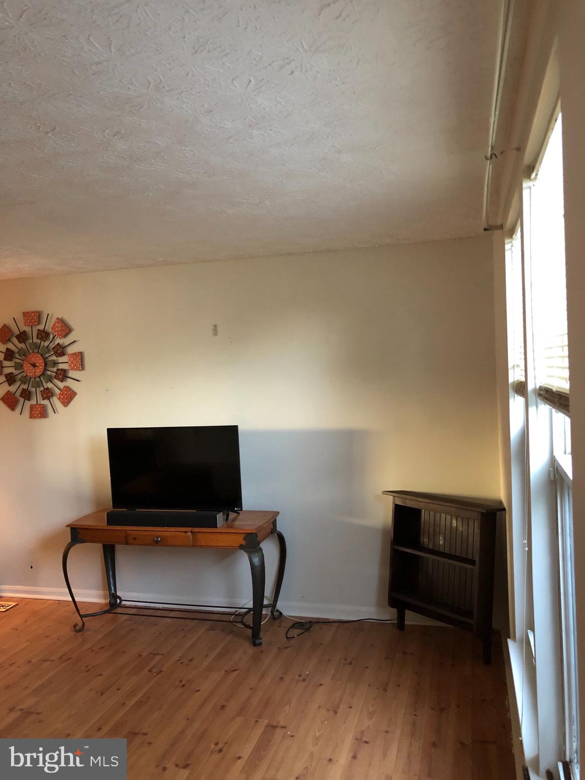 4 Hyacinth Road Baltimore, MD 21234 - Photo 5 of 33 a living room with a couch and a flat screen tv