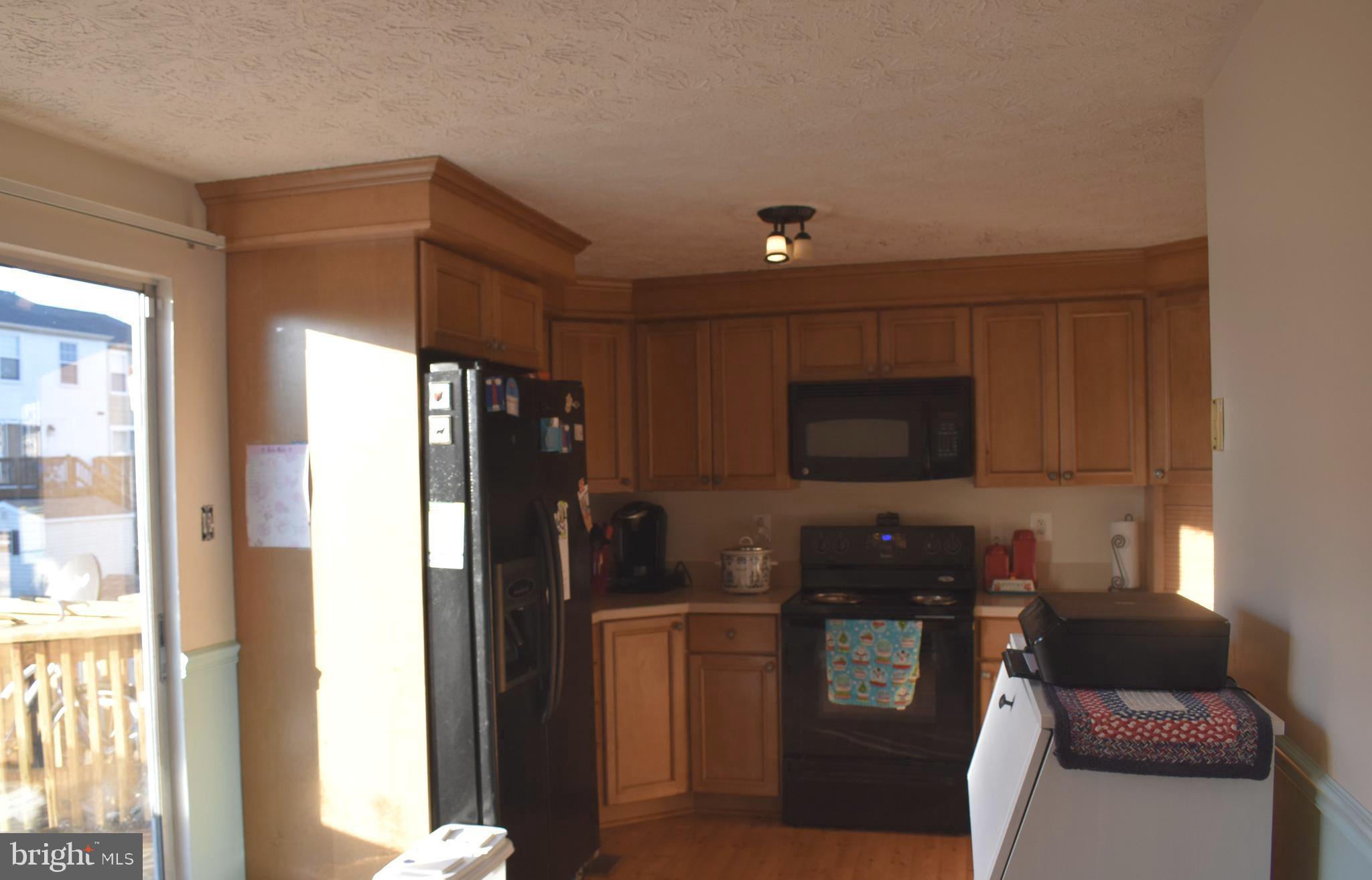 4 Hyacinth Road Baltimore, MD 21234 - Photo 10 of 33 a kitchen with stainless steel appliances granite countertop a refrigerator and a stove top oven