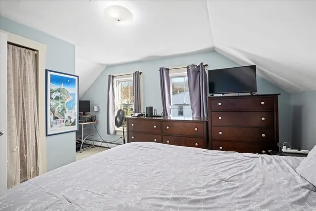 a bedroom with a bed and a dresser