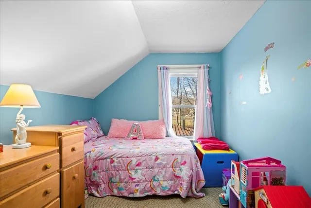 a bedroom with a bed and a lamp