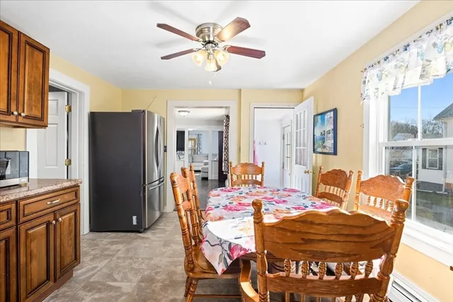 a view of a dining room with furniture a kitchen and chandelier