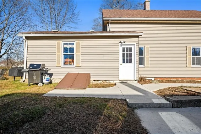 a view of a house with backyard and sitting area