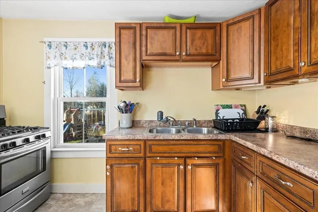 a kitchen with stainless steel appliances granite countertop a refrigerator and stove