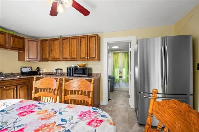 a very nice looking bedroom with a bed dresser and a large window